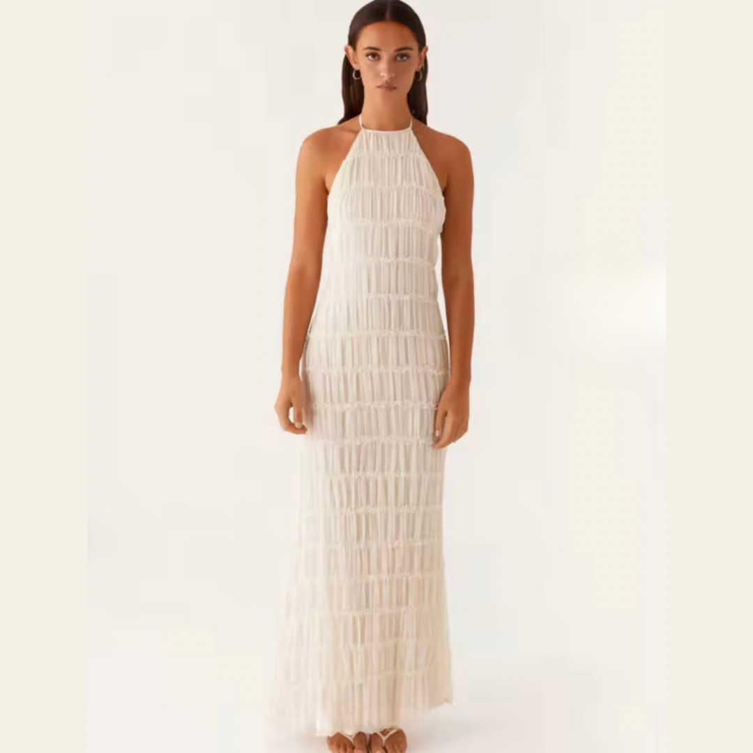 Model trägt strukturiertes Halterneck-Sommerkleid in Vorderansicht – figurbetontes Design in Weiß.
