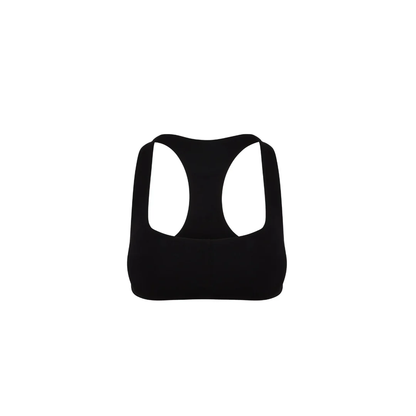 Freigestellter Core Calm Seamless Bra in Schwarz, Vorderansicht – nahtloser Sport-BH mit Racerback, auf weißem Hintergrund.